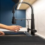 Turning off the under sink water supply before fixing a kitchen faucet leak