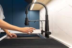 Turning off the under sink water supply before fixing a kitchen faucet leak